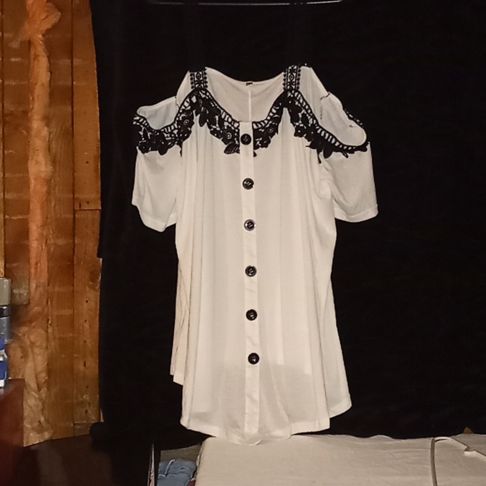 White and black blouse with open shoulder. Lace shoulder straps and black button